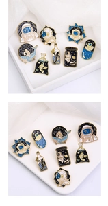 Detailed close-up of astronaut and starry whale enamel pins with gold-plated zinc alloy edges