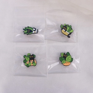 Detailed set of four cartoon black cat and green plant enamel brooches with backing