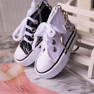 Miniature canvas shoe keychains in black and white styles with metallic rings