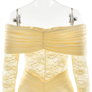 Close-up of yellow off-shoulder dress with ruched chest and sheer lace sleeve details