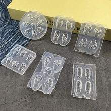 Macro view of six clear silicone nail molds featuring lace and totem embossed patterns