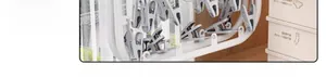 Close-up of multifunctional white drying rack with gray clips and laundry storage box