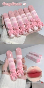 Close-up of velvet matte lip glazes in pink gradient tubes with 3D bear ornaments