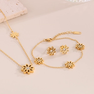 Close-up of golden sunflower jewelry set including necklace, bracelet and stud earrings