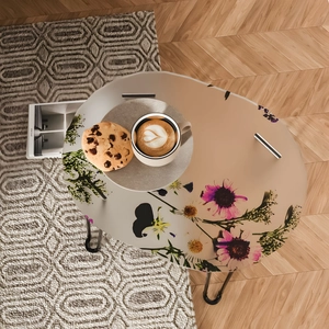 Oval tray table with purple and yellow floral patterns on black metal legs