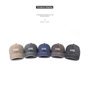Flat lay of five washed cotton baseball caps with KING embroidery in multiple vintage colors