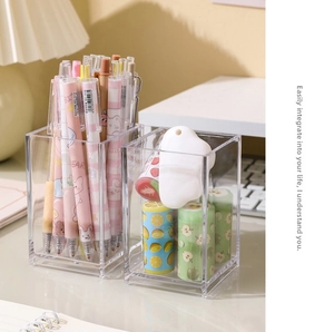 Close-up of clear acrylic desk organizer holding pens and stationery on a neat workspace