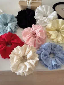 Close-up of assorted eyelet lace scrunchies in various colors with high-quality texture