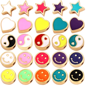 Colorful enamel beads set with gold trim featuring stars, hearts, and smiley patterns