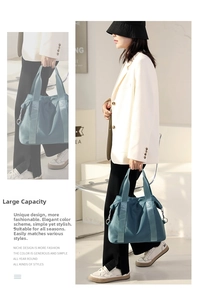 Detail showing durable matte nylon texture and practical large capacity tote bag features