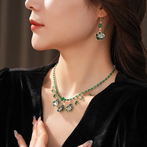 Elegant floral jewelry set featuring green zircon pendant necklace and earrings on model