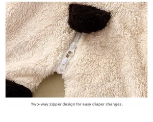Detail of baby romper featuring warm coral fleece texture and two-way diaper zipper