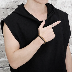 Detail of men's braided leather double-layer bracelet with silver metal ring on model