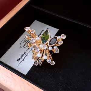 Vintage palace style brooch with olive green zircon and pearls on gold metal