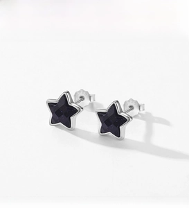 Macro detail of S925 sterling silver star earrings with sparkling blue obsidian inlay