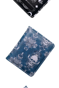 Detail of gothic skull pattern wallets in blue and black leather with zipper closure