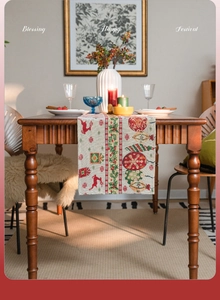 Detail shot of vintage Christmas table runner with festive jacquard deer and wreath patterns
