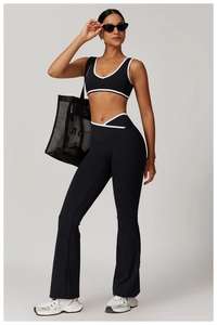 Detail of cross high-waisted contrast yoga set with backless sports bra and flared pants