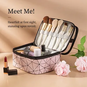 Pink geometric PU makeup bag with multiple brushes and cosmetics for travel storage