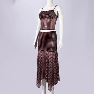 Detail of burgundy polka dot mesh two-piece set featuring ruched crop top and asymmetric skirt