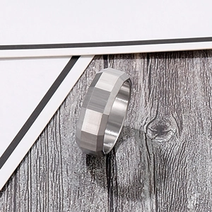 Detail of 8mm brushed silver stainless steel ring with faceted edges and matte finish