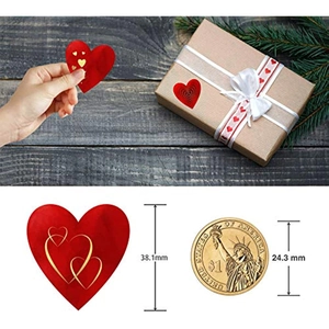 Detailed view of a 38mm heart-shaped adhesive label on a kraft gift box with red ribbon