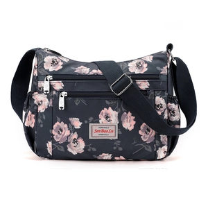 Floral print navy nylon crossbody bag with multi-zipper pockets and adjustable strap