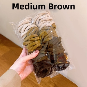 Detail view of medium brown elastic hair ties in various shades of coffee and beige