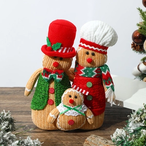 Three-piece set of Christmas gingerbread man plush dolls on a festive wooden surface