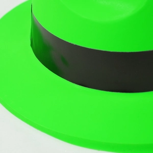 Macro detail of neon green party hat with wide black decorative ribbon and smooth texture