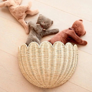 Handwoven semicircular rattan wall basket with scalloped lace edges for home storage