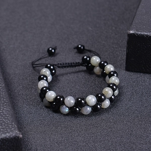 Detail of double-layer woven bracelet with black beads and labradorite stones