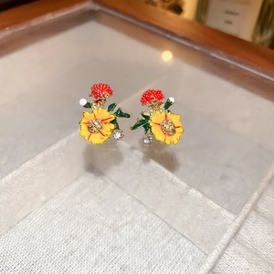 Detailed close-up of small floral earrings with colorful petals and zircon stone accents