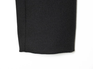 Detailed macro view of black twill woven fabric showing precise stitching on the cuff