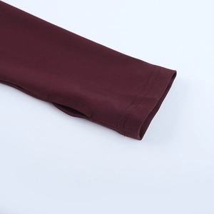 Detail of wine red yoga top sleeve with thumbhole design and elastic knit texture