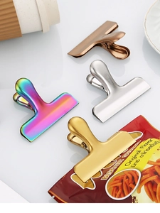 Detailed view of T-shape stainless steel clips in gold, silver, bronze, and rainbow colors