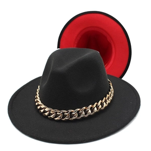 Detail of fedora hat with gold acrylic chain and vibrant red interior contrast lining