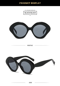 Detail view of bold black oval frames and dark grey lenses for these outdoor sunglasses