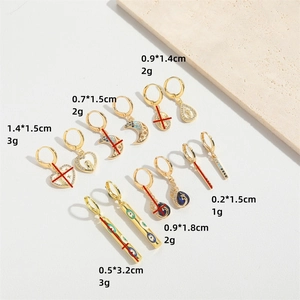 Gold evil eye heart dangle earrings set with colorful crystals and celestial designs