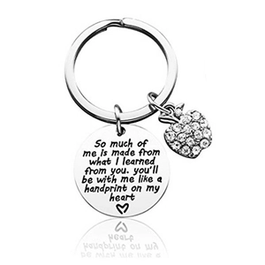 Detail of silver stainless steel keychain with crystal apple and engraved teacher quote