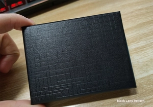 Detailed view of a black gift box featuring a distinct linen textured finish