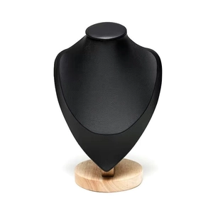 Detail of black leather necklace bust display with a solid round wooden base