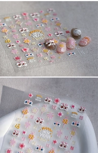 Detail of 3D embossed nail stickers featuring festive Chinese New Year lion and floral patterns