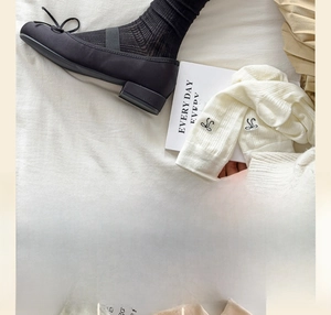 Détail de chaussettes résille style ballerine avec nœuds et motifs brodés fins
