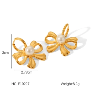 Macro shot showing dimensions of 18K gold stainless steel bow pearl earrings