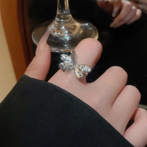 Close-up of a silver butterfly ring with cubic zirconia on a model hand with luxury vibes