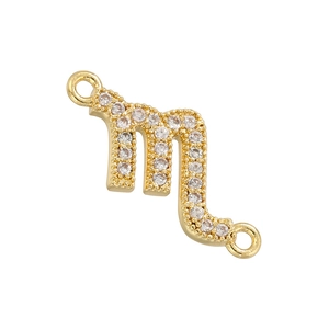 Macro shot of gold-plated Scorpio zodiac connector with pavé-set clear zircon stones