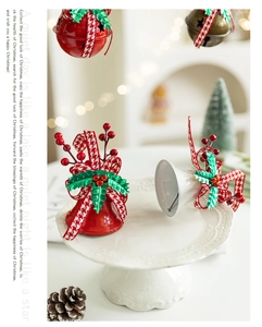 Detail of red and white Christmas bells with plaid ribbons and festive holly berry accents