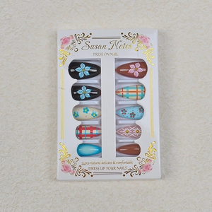 Detail of Christmas press-on nails set with 3D floral designs and vintage patterns