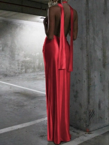 Elegant red satin halter maxi dress with backless design and long decorative streamers